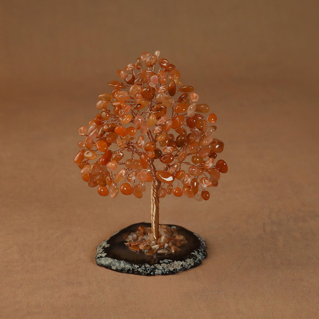 Rooted crystal tree with orange carnelian chips on a round stone base