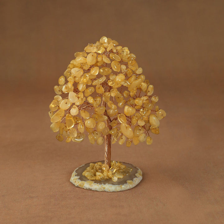 Rooted crystal tree with yellow citrine chips on a round stone base