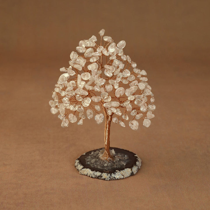 Rooted crystal tree with clear quartz chips on a round stone base