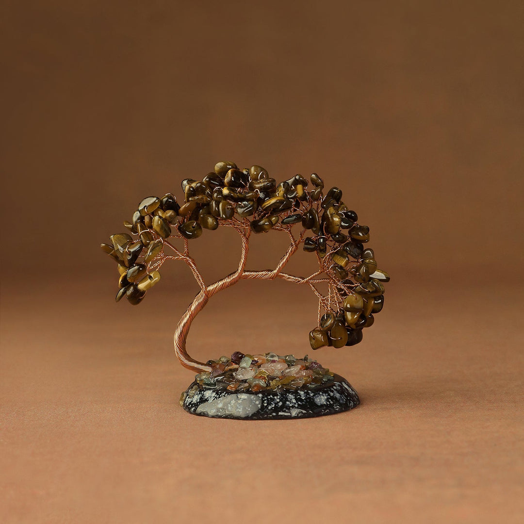 Brown beaded crystal tree ornament with copper wire branches on a stone base