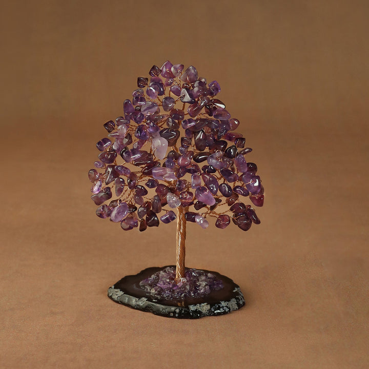 Rooted crystal tree with purple amethyst chips on a round stone base
