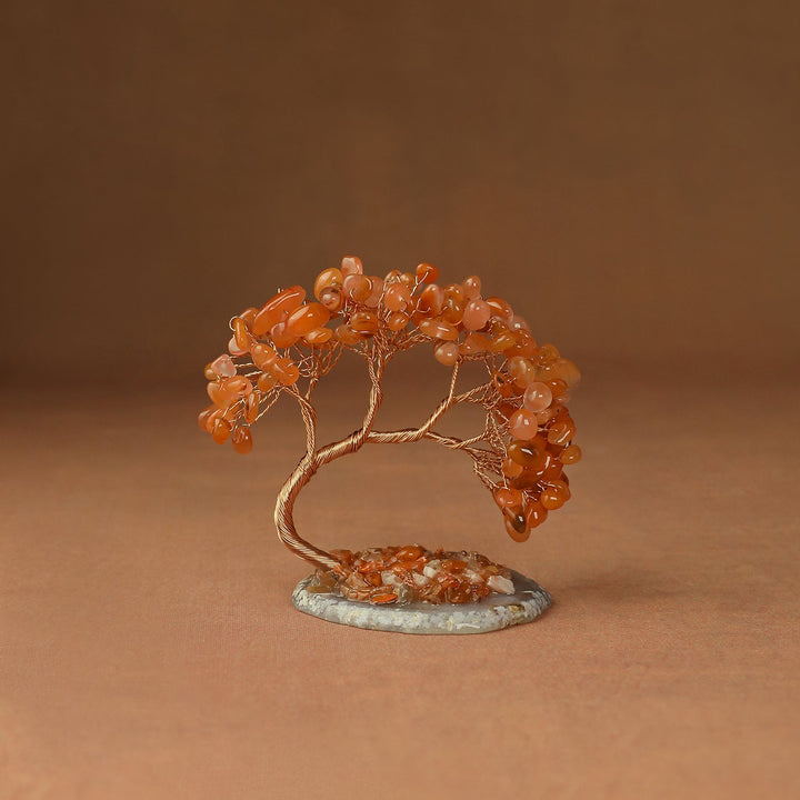 Orange gemstone crystal tree with wire trunk and beaded branches on a round stone base