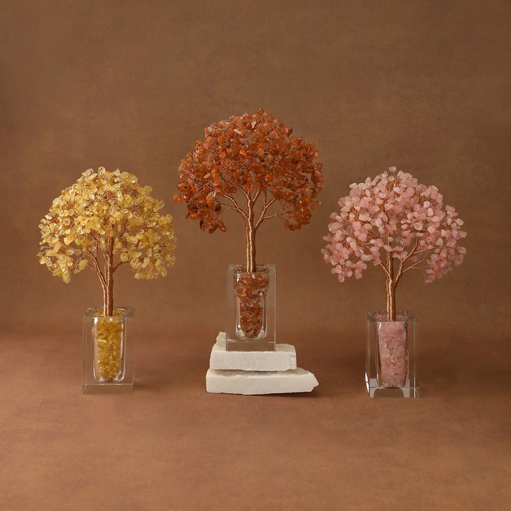 Three crystal tree ornaments with amber, dark orange, and pink bead canopies