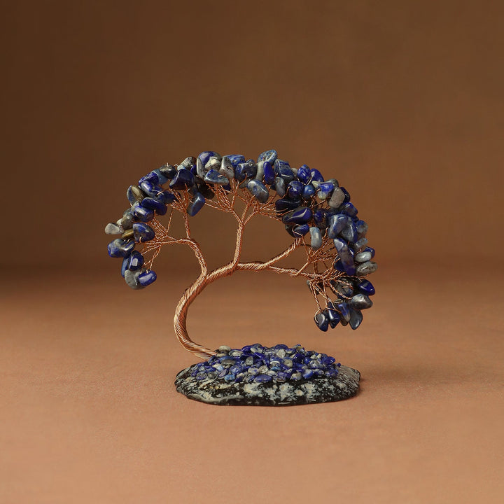 Blue beaded crystal tree ornament with copper wire branches and a stone base