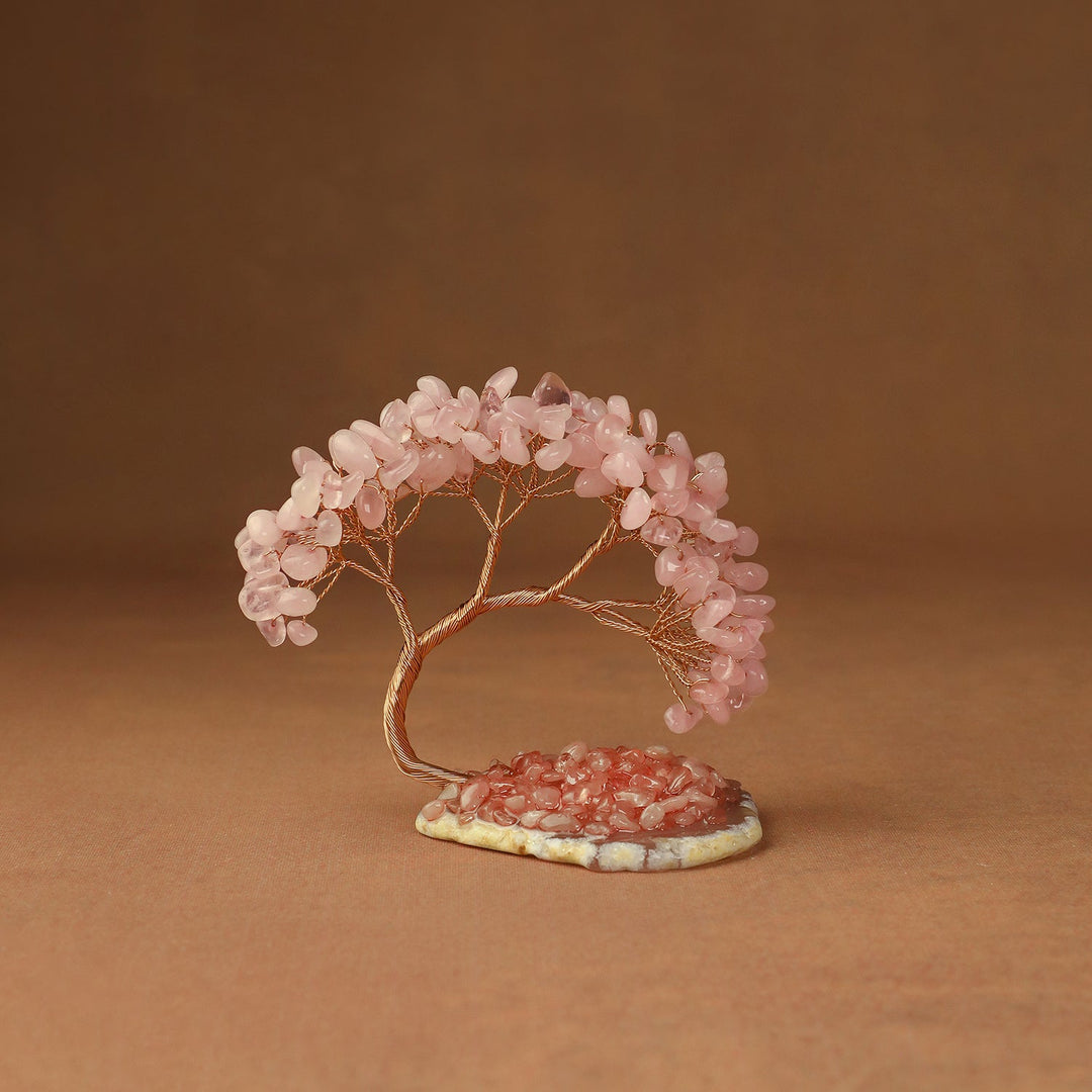 Pink gemstone crystal tree with wire trunk and leaves on a small stone base