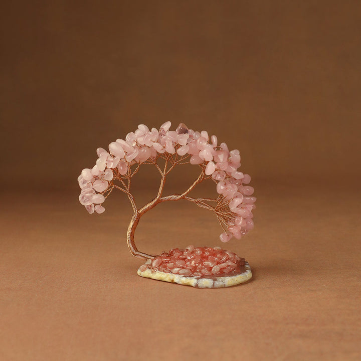 Pink gemstone crystal tree with wire trunk and leaves on a small stone base