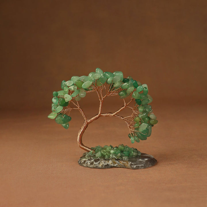 Green gemstone crystal tree with wire trunk and beaded branches on a stone base
