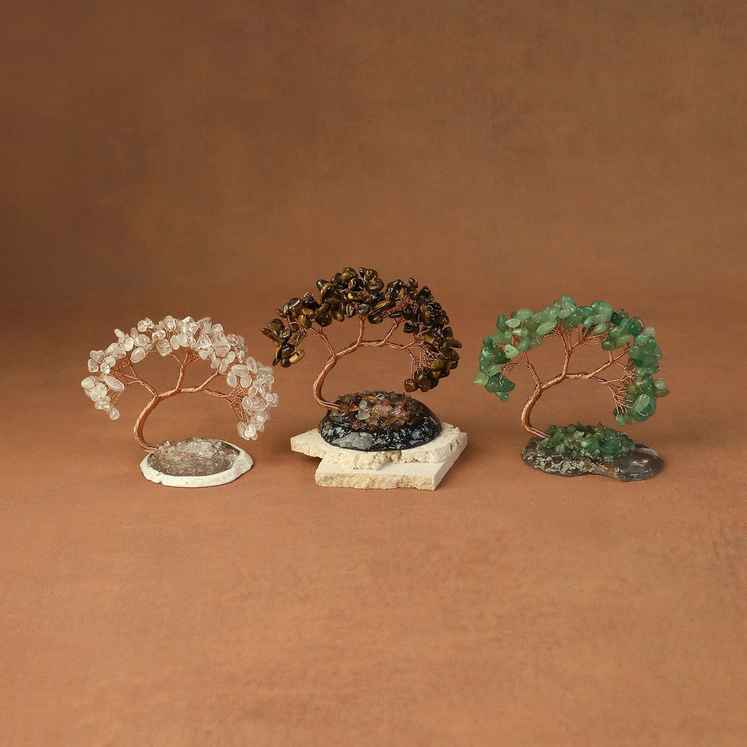 White, black, and green beaded crystal tree ornaments on stone bases