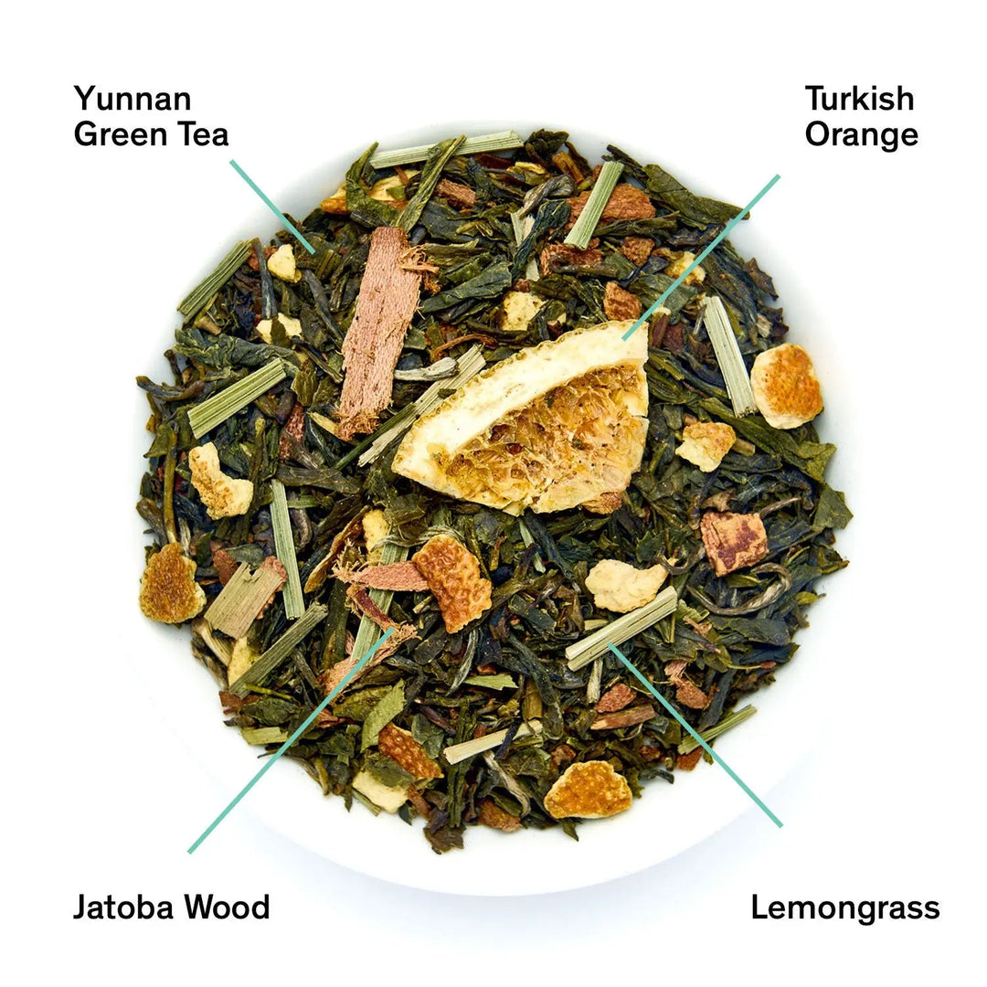 Green tea blend with citrus and vanilla orange pieces in bowl