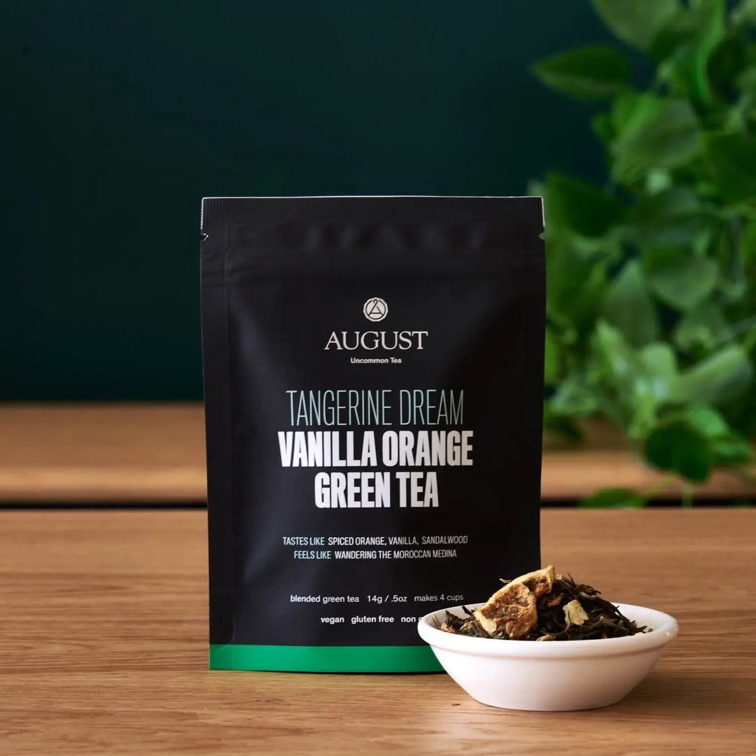 Black green tea pouch with vanilla orange label and loose tea bowl