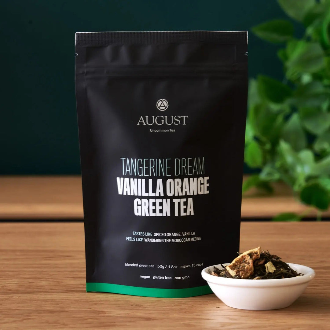 Black green tea pouch back label view with small bowl of loose tea