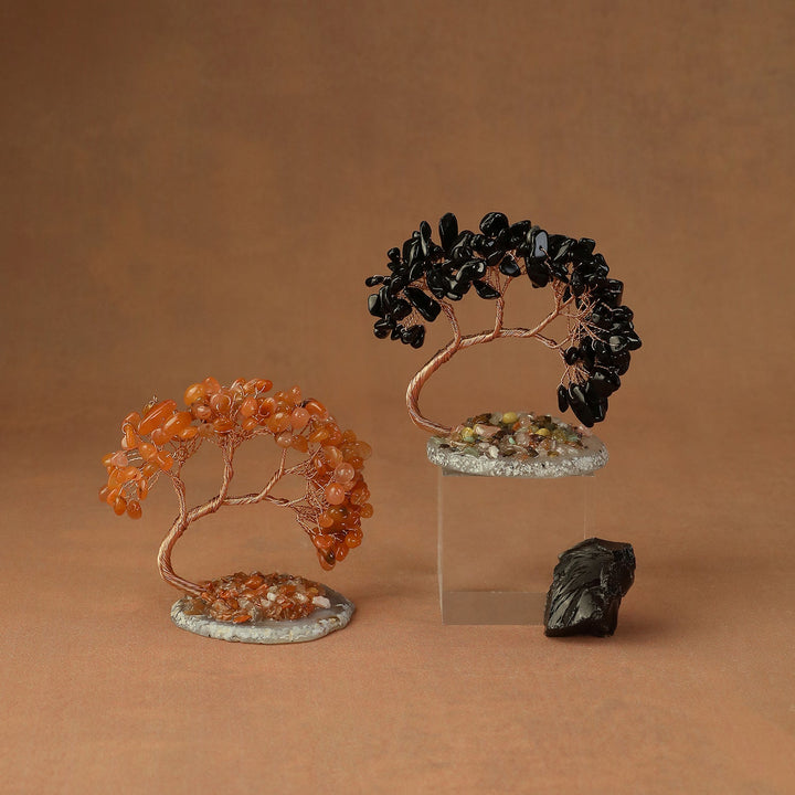 Black and orange beaded crystal tree ornaments on stone bases