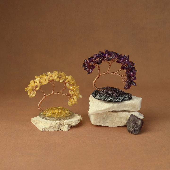 Pair of beaded crystal tree ornaments—gold and purple—with stone bases