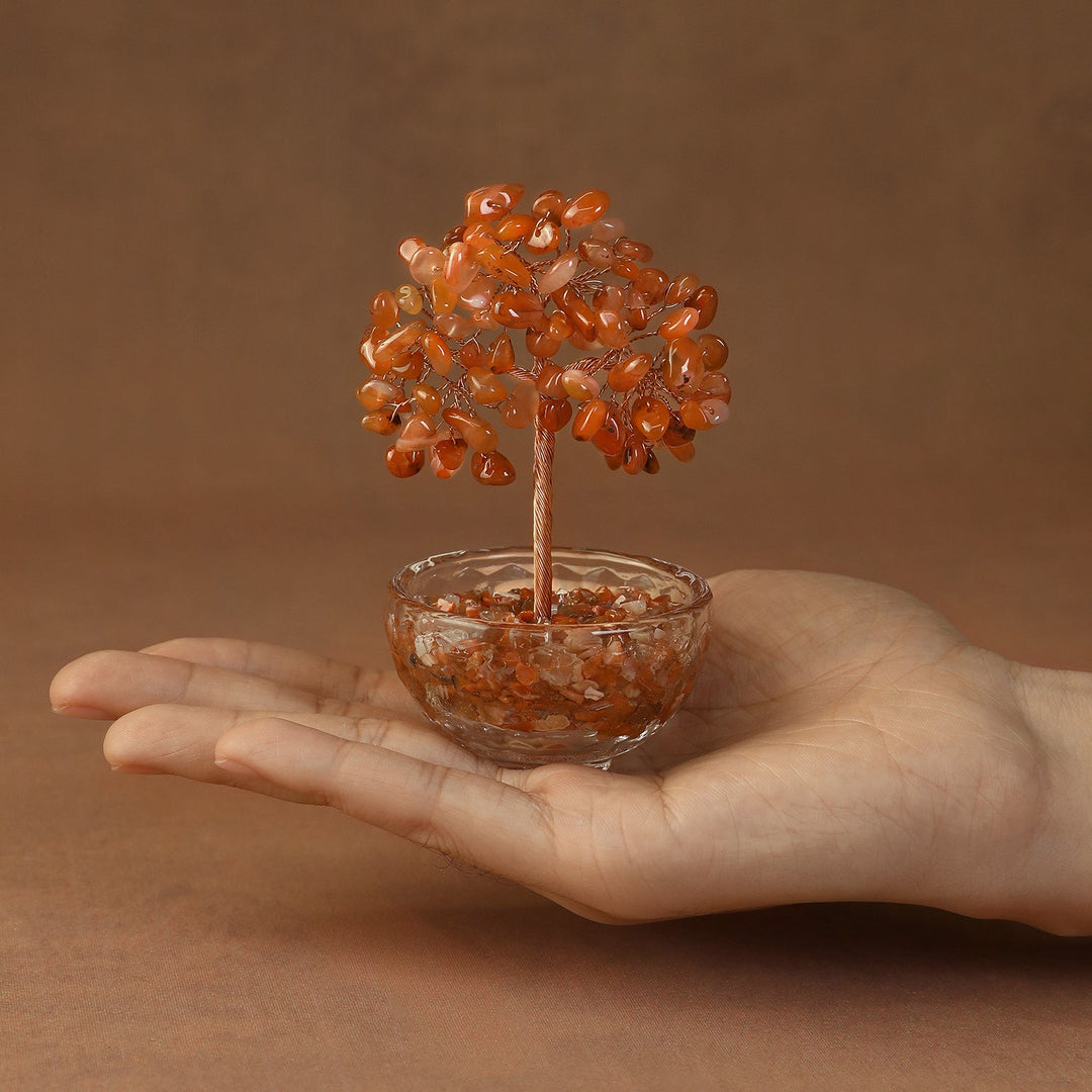 Orange crystal gemstone tree with beaded canopy in a tinted resin bowl, held in hand