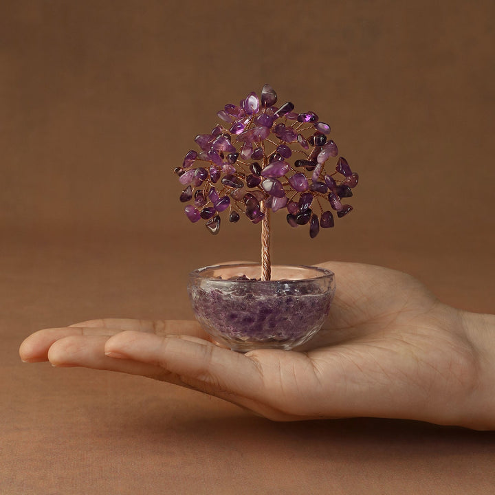 Purple crystal tree ornament with gem-like branches in clear glass bowl