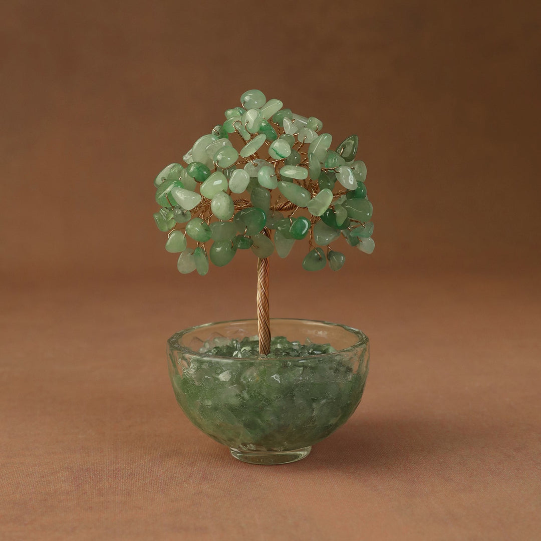 Green crystal tree ornament with bead branches in a clear glass bowl