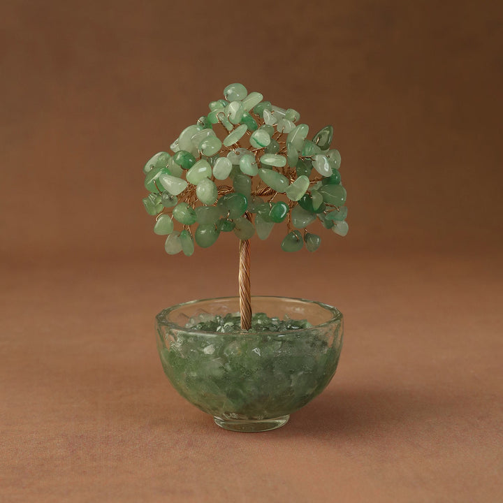 Green crystal tree ornament with bead branches in a clear glass bowl