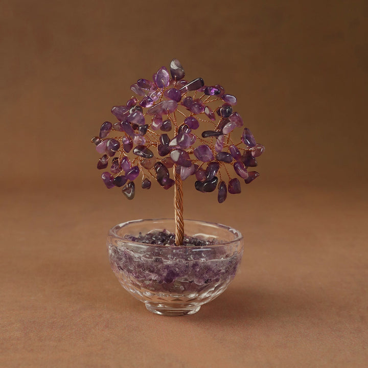 Purple crystal tree ornament with beaded branches in a clear glass bowl