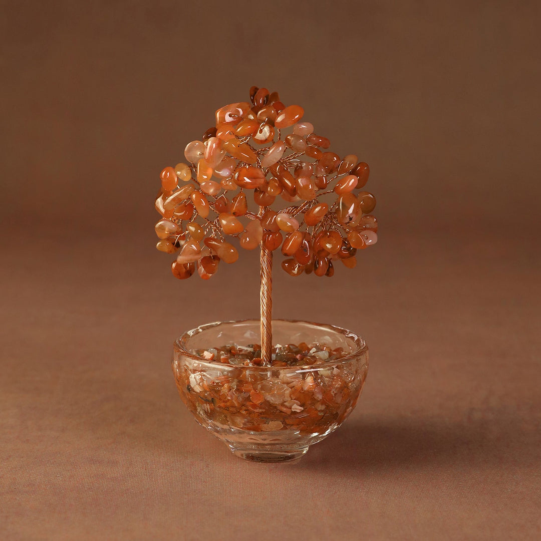 Orange crystal tree ornament with bead branches in a clear glass bowl
