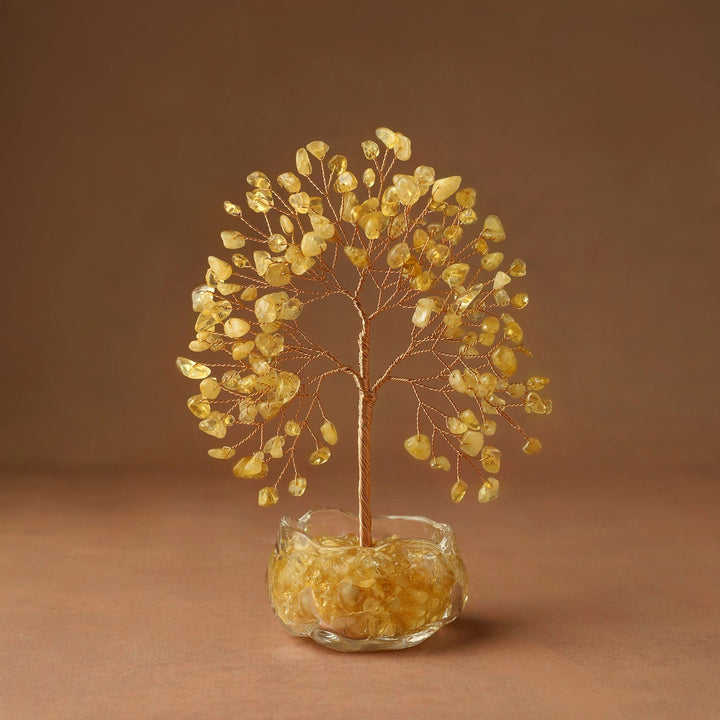 Crystal tree decor with golden yellow gem leaves and wire trunk in glass base