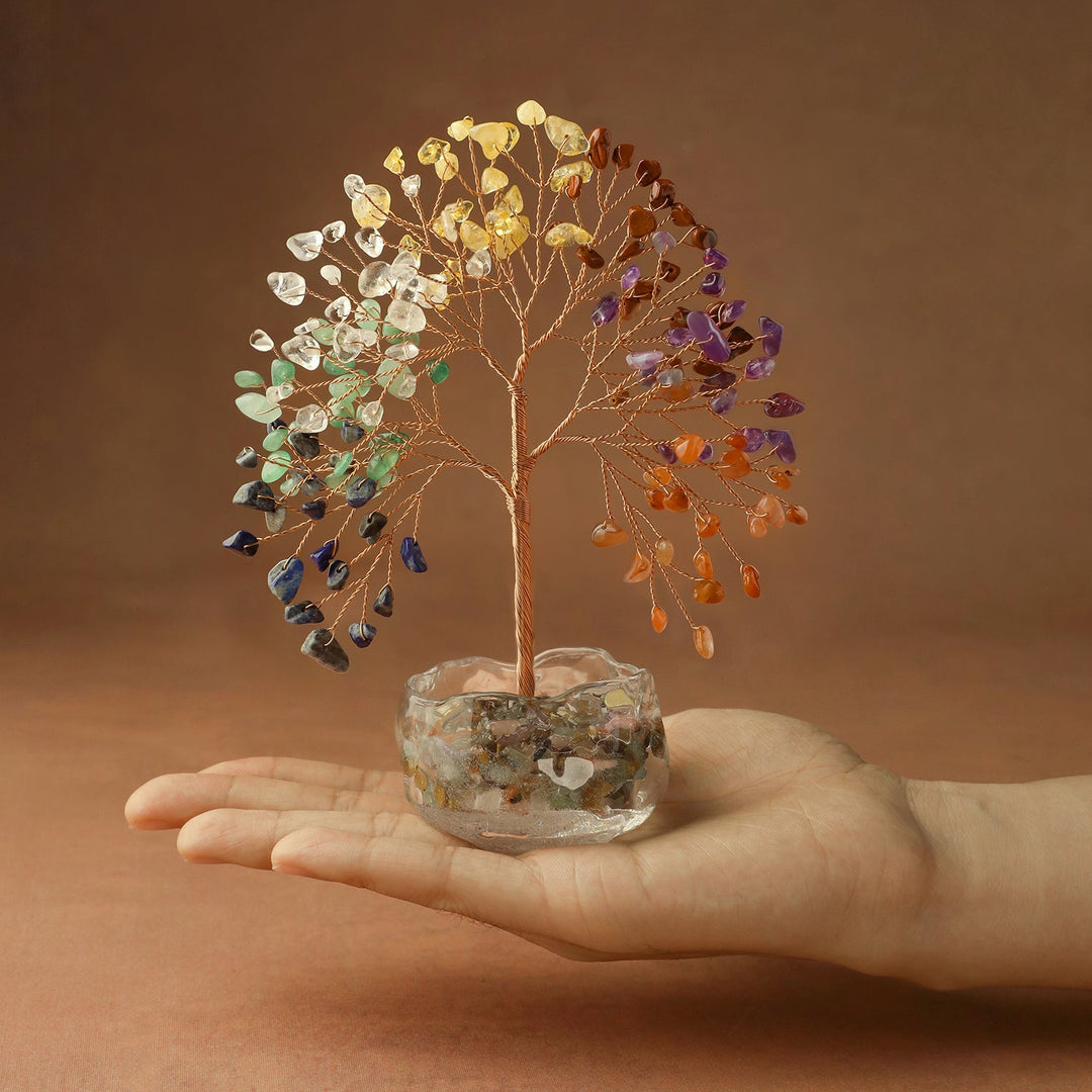 Multicolor crystal tree in clear glass bowl, shown above a hand