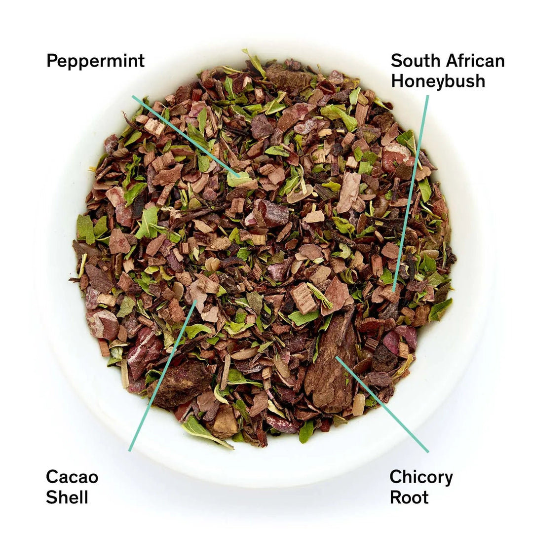 Loose herbal tea leaf mix in bowl with peppermint, honeybush, cacao shell, and chicory root