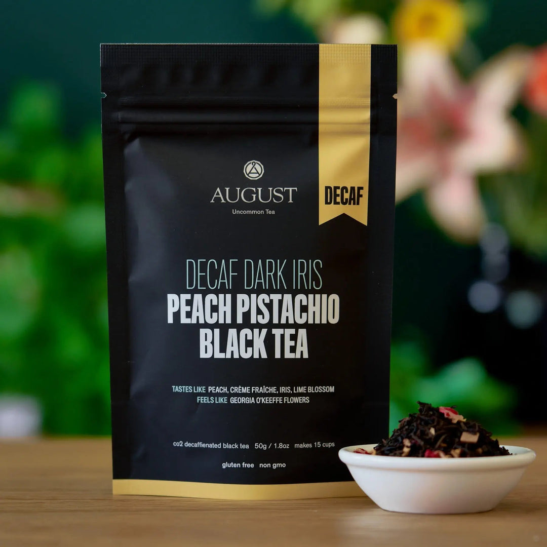 Black tea decaf pouch with peach, pistachio, and dark iris flavor blend
