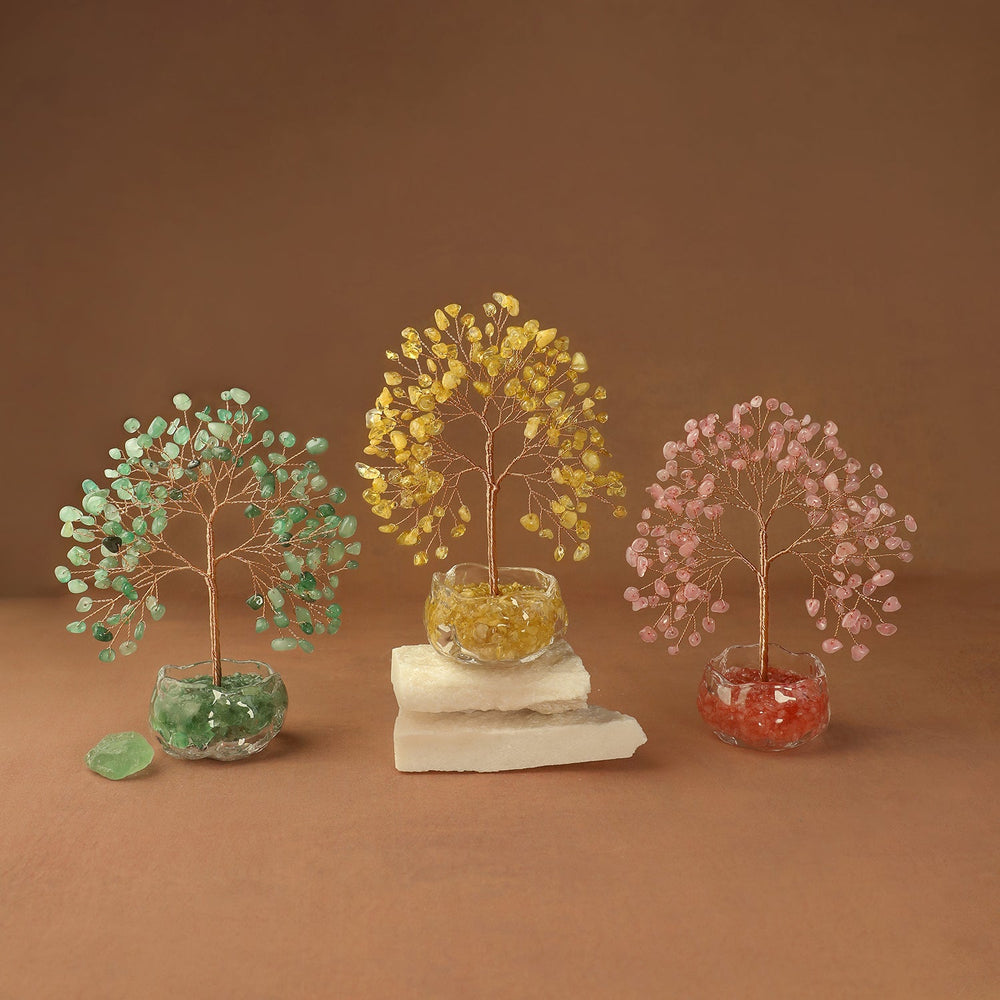 Gemstone crystal tree with green, gold, and pink branches in stone bases