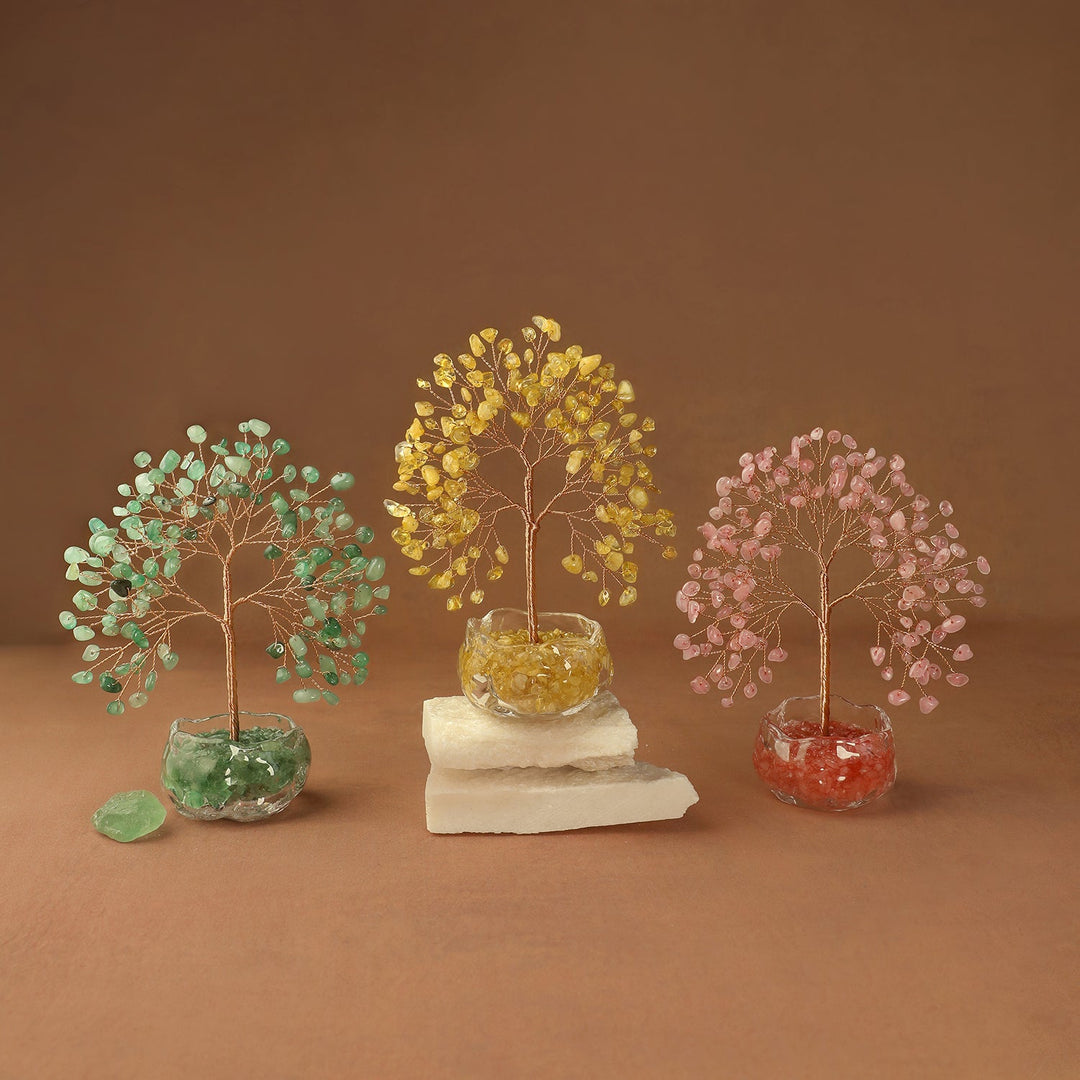 Gemstone crystal tree with green, gold, and pink branches in stone bases