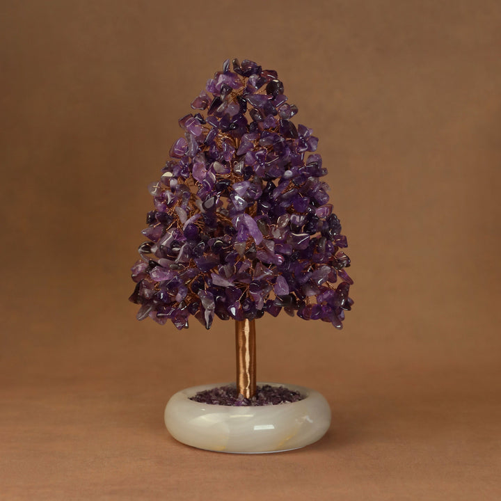 Purple amethyst-style crystal tree ornament with dense clusters on a white stone base