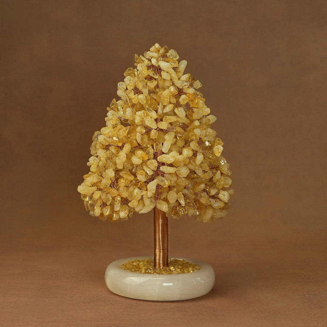 Golden yellow crystal tree ornament with clustered crystals on a white stone base