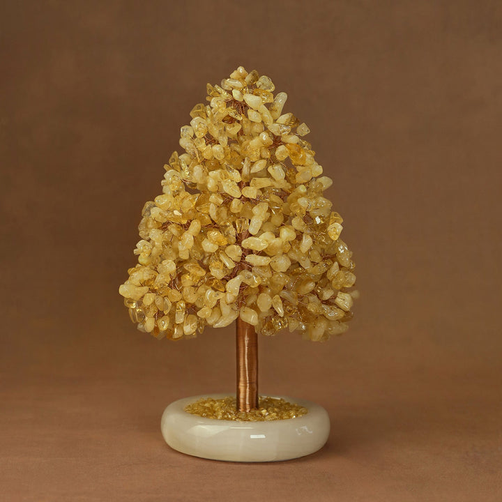 Golden yellow crystal tree ornament with clustered crystals on a white stone base
