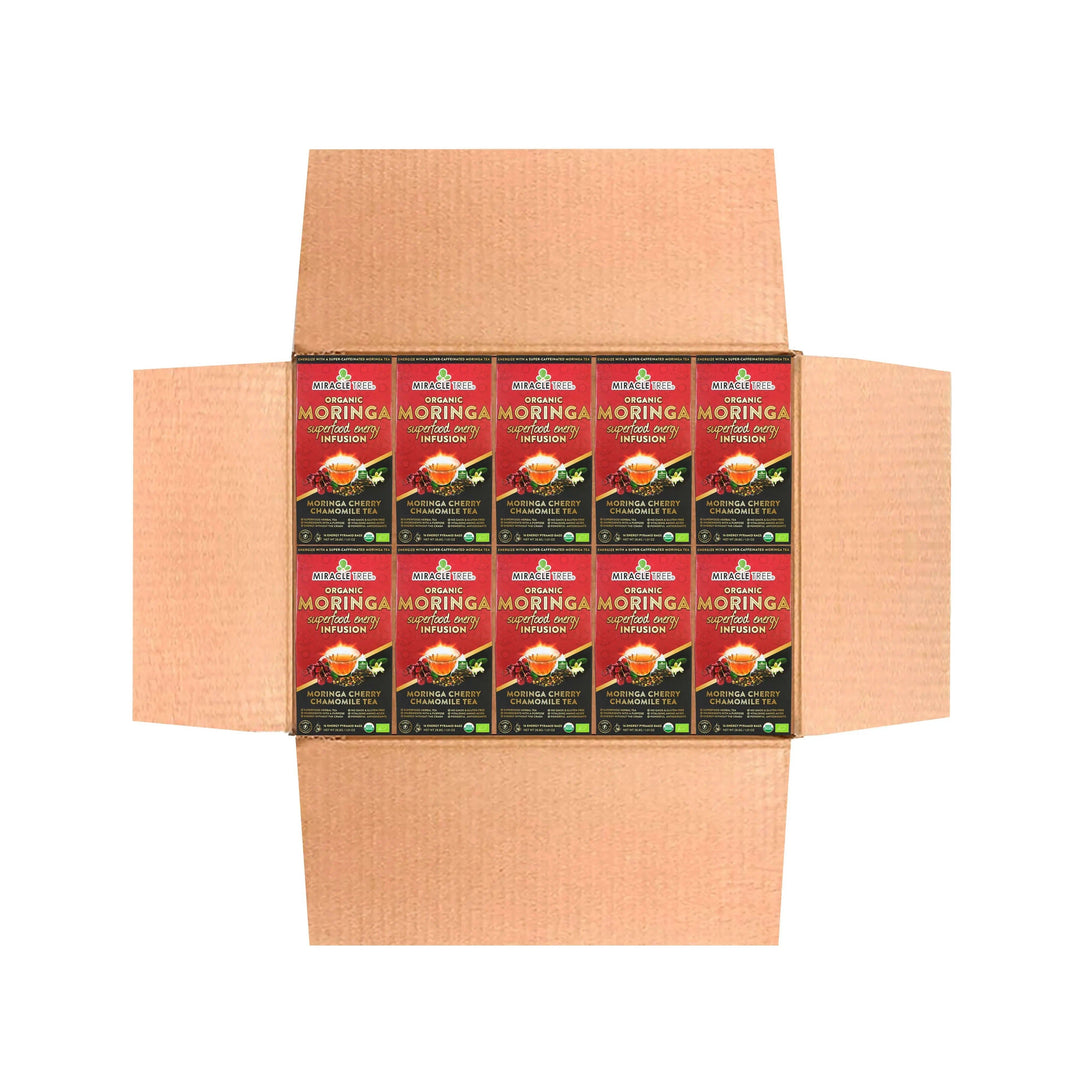 Cardboard shipping carton holding multiple Miracle Tree organic moringa tea boxes