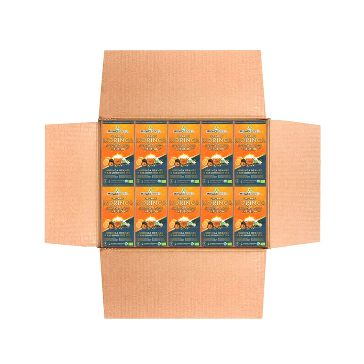 Cardboard shipper with multiple Miracle Tree Organic Moringa tea pouches, front view