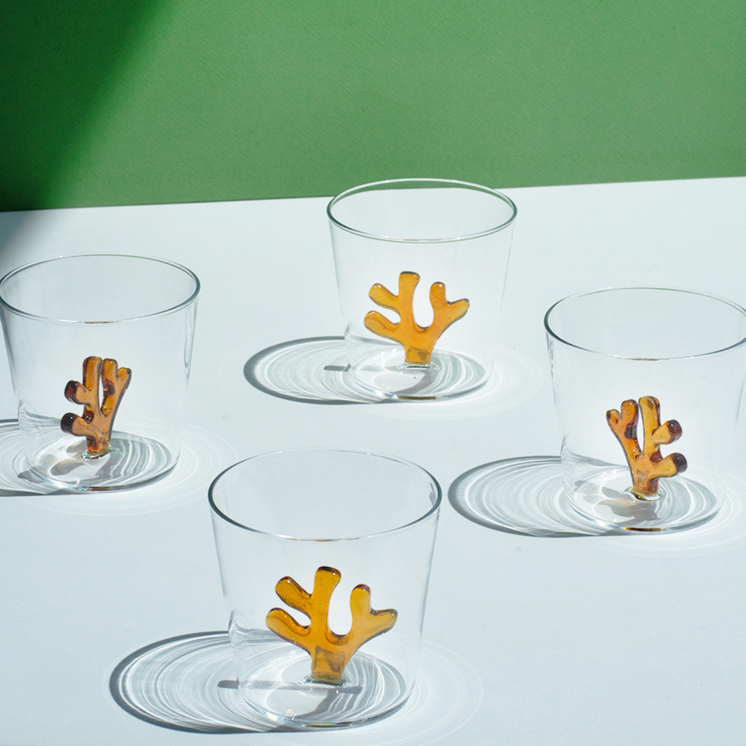 Set of clear glass water tumblers with orange coral inserts