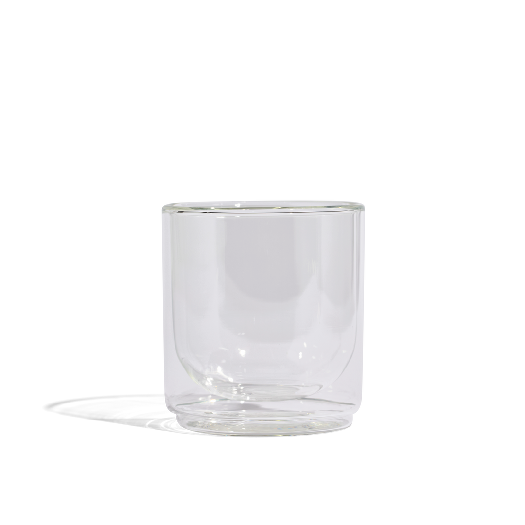 Clear glass tumbler with rounded sides and thick base