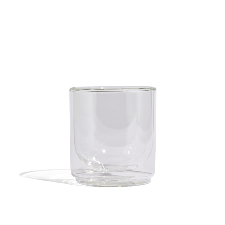 Clear glass tumbler with rounded sides and thick base