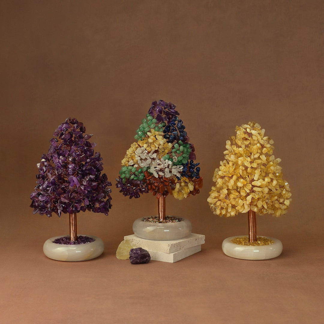 Set of three crystal tree ornaments with purple, green-and-blue, and yellow clusters on white bases