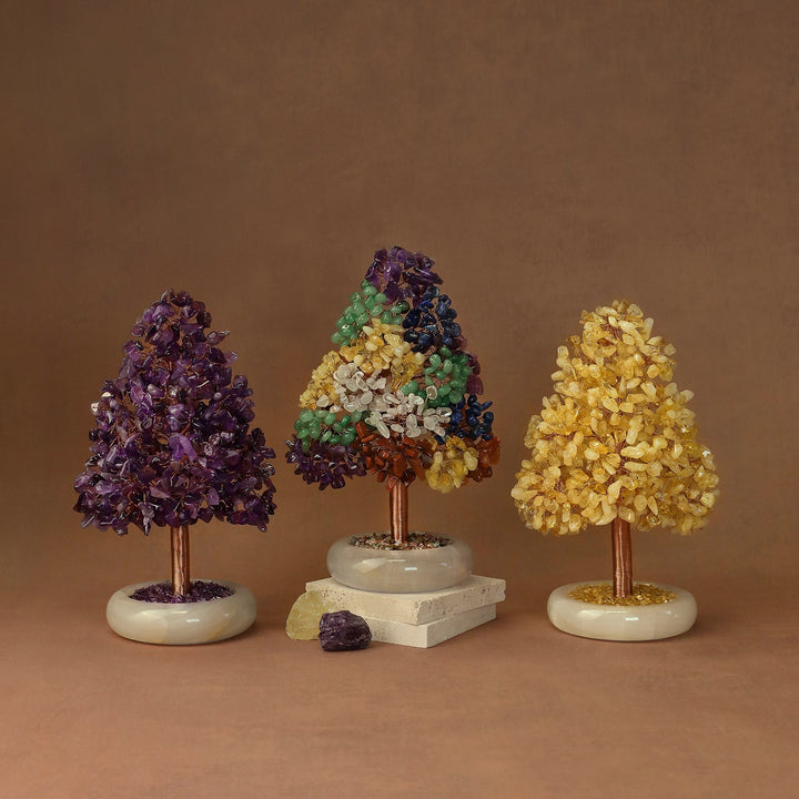 Set of three crystal tree ornaments with purple, green-and-blue, and yellow clusters on white bases