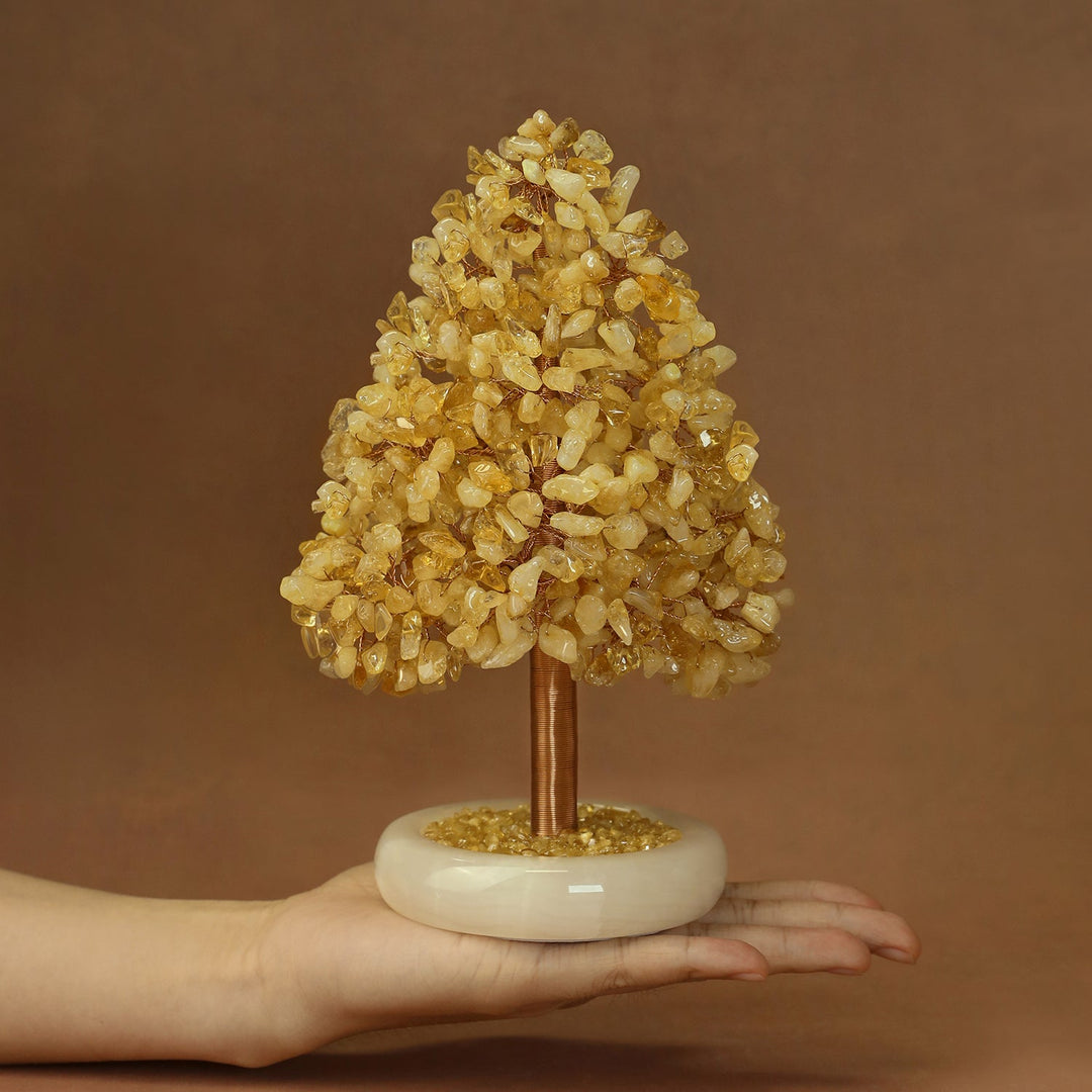 Yellow crystal tree ornament with sparkling stone clusters and gold-toned trunk on base