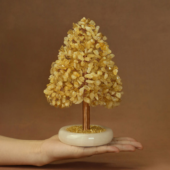Yellow crystal tree ornament with sparkling stone clusters and gold-toned trunk on base