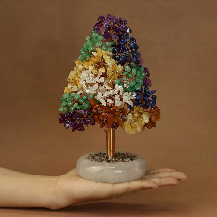 Multi-color crystal tree ornament with purple, green, yellow, and blue clusters on a white marble base