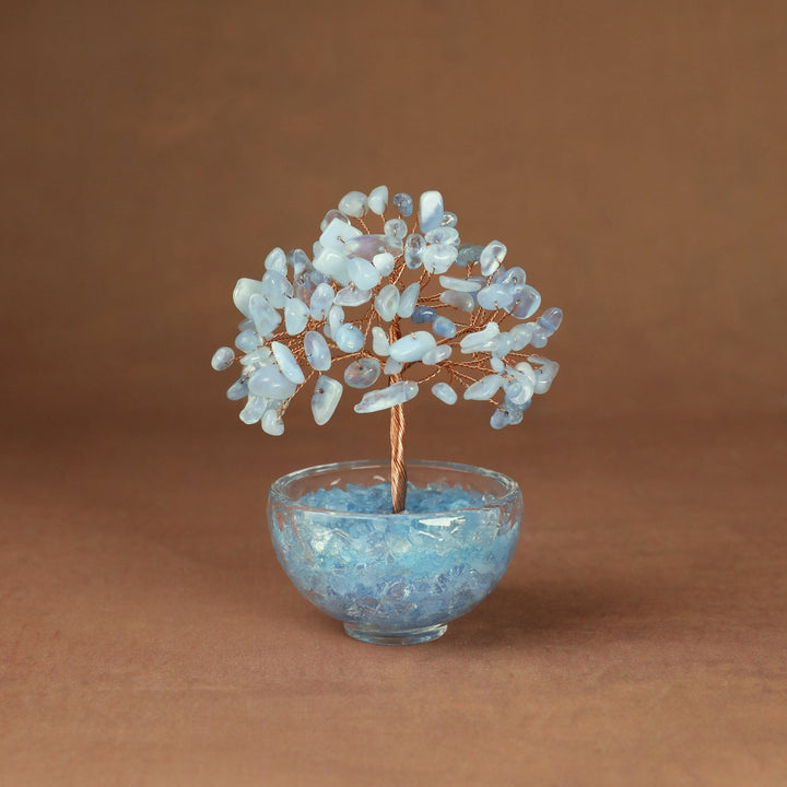 Light blue crystal tree ornament with beaded branches in a clear glass bowl