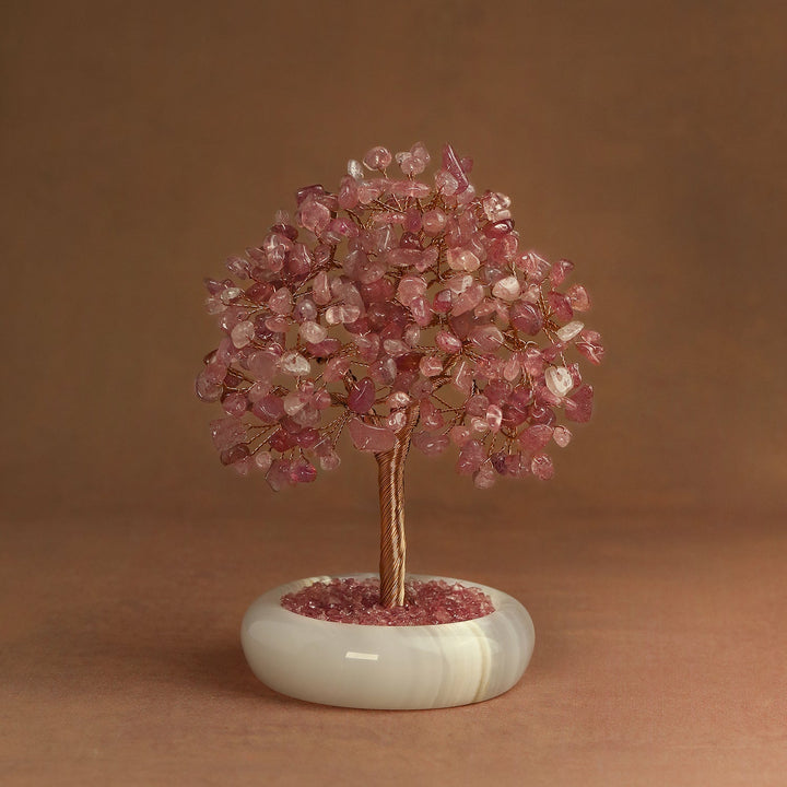 Rose quartz crystal tree with gold-toned wire trunk and round white base