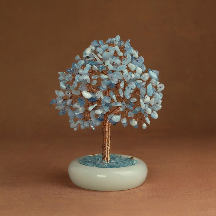 Aquamarine crystal tree with gold-toned wire trunk and round light base