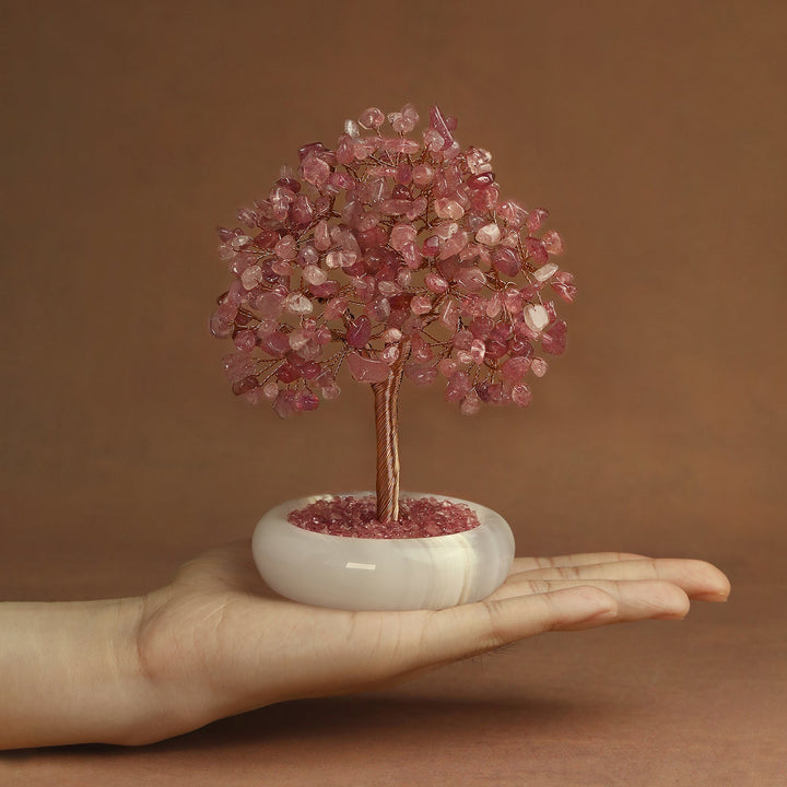 Pink crystal gemstone tree on white round jade-style base