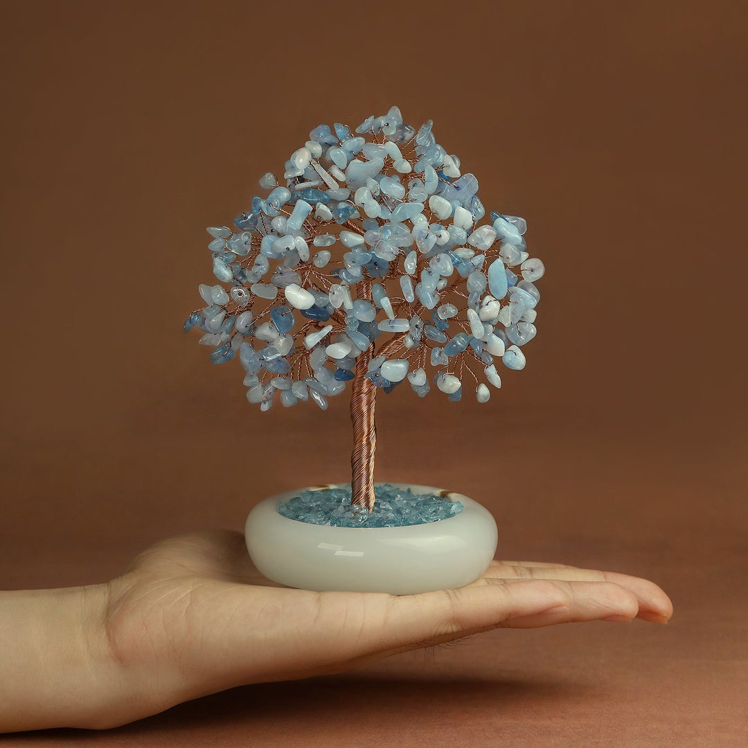 Light blue crystal gemstone tree on white round jade-style base