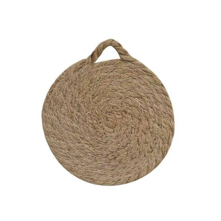 Round woven natural trivet with top handle loop, centered on white background