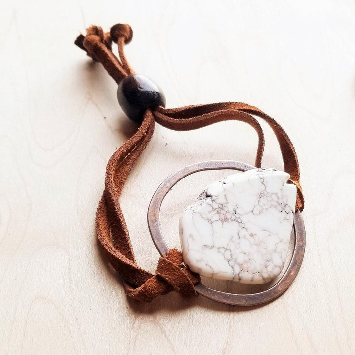 Adjustable tie bracelet with brown suede cord and circular metal bezel with white stone
