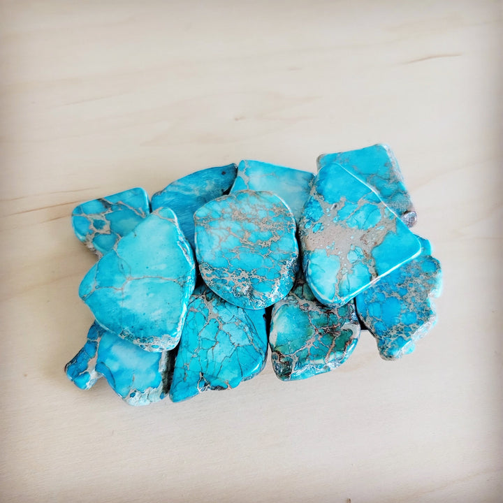 Turquoise slab belt buckle with clustered blue stones and a central oval stone